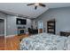 Large bedroom area features gray walls, wood flooring, a bed, and a fireplace at 5307 Green Riley Rd, Rougemont, NC 27572