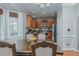 An open dining area with wood floors, a bay window, and a view leading into the kitchen at 5307 Green Riley Rd, Rougemont, NC 27572