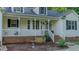 Home exterior with a covered porch, lush front yard, and a tranquil atmosphere at 5307 Green Riley Rd, Rougemont, NC 27572