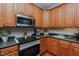This kitchen shows off custom wood cabinets, stainless steel appliances, and granite countertops at 5307 Green Riley Rd, Rougemont, NC 27572