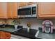 Kitchen area featuring a smooth cooktop, stylish microwave, and decorative accents at 5307 Green Riley Rd, Rougemont, NC 27572