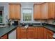 Functional kitchen with wooden cabinets, an undermount sink, and natural lighting at 5307 Green Riley Rd, Rougemont, NC 27572