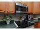 This kitchen shows off custom wood cabinets, stainless steel appliances, and dark countertops at 5307 Green Riley Rd, Rougemont, NC 27572