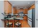 Open kitchen with lots of wood cabinets, an island with seating, and stainless-steel appliances at 5307 Green Riley Rd, Rougemont, NC 27572