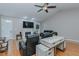 Living room with hardwood floors, TV, fireplace and comfortable leather seating with a ceiling fan at 5307 Green Riley Rd, Rougemont, NC 27572