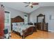 A traditionally styled primary bedroom features a large bed, ceiling fan, and wood floors at 5307 Green Riley Rd, Rougemont, NC 27572