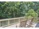 Back deck with views of woods and chairs with small glass tables at 5328 Willow Cry Ln, Raleigh, NC 27613