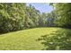 Expansive backyard with lush green lawn, perfect for recreation and outdoor activities at 5328 Willow Cry Ln, Raleigh, NC 27613