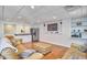 Basement living area with wet bar, stainless refrigerator, hardwood floors and comfortable seating at 5328 Willow Cry Ln, Raleigh, NC 27613