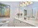 Bathroom featuring neutral countertops, a large mirror, and a decorative painting at 5328 Willow Cry Ln, Raleigh, NC 27613