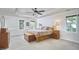 Spacious bedroom with ample natural light, neutral tones, and a ceiling fan at 5328 Willow Cry Ln, Raleigh, NC 27613