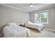 This bedroom contains two twin beds, a ceiling fan and natural light at 5328 Willow Cry Ln, Raleigh, NC 27613