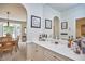Elegant dining room with a built-in bar area, natural light, and adjacent dining area at 5328 Willow Cry Ln, Raleigh, NC 27613