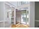 Bright foyer with hardwood floors, large windows, and an open view to the living room and front yard at 5328 Willow Cry Ln, Raleigh, NC 27613