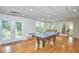 Spacious game room with ping pong table, foosball, hardwood floors, recessed lighting, and natural light at 5328 Willow Cry Ln, Raleigh, NC 27613