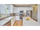 Bright kitchen with white cabinets, stainless steel appliances, and a center island at 5328 Willow Cry Ln, Raleigh, NC 27613