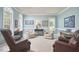 Well-lit living room features comfortable seating, neutral decor, and large windows with natural light at 5328 Willow Cry Ln, Raleigh, NC 27613