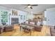 Open-concept living room featuring a fireplace, hardwood floors, and a view into the kitchen at 5328 Willow Cry Ln, Raleigh, NC 27613