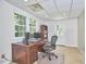 Office with large windows, drop ceiling, hardwood desk, and neutral walls at 5328 Willow Cry Ln, Raleigh, NC 27613