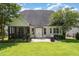 Spacious backyard patio featuring outdoor seating, a grill, and lush landscaping at 5629 Clearsprings Dr, Wake Forest, NC 27587