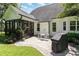 Charming backyard patio with outdoor seating and a grill, surrounded by lush greenery at 5629 Clearsprings Dr, Wake Forest, NC 27587