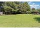 Well-maintained backyard with lush green grass and mature trees at 5629 Clearsprings Dr, Wake Forest, NC 27587