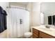 Bright bathroom with a vanity sink, toilet, and shower featuring a black-and-white striped curtain at 5629 Clearsprings Dr, Wake Forest, NC 27587