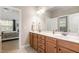 Bright bathroom featuring double vanity sinks with wood cabinets at 5629 Clearsprings Dr, Wake Forest, NC 27587