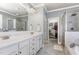 Bright bathroom featuring double vanity sinks, a soaking tub, and a separate glass-enclosed shower with a walk-in closet at 5629 Clearsprings Dr, Wake Forest, NC 27587
