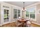 Bright dining area features a wood table, chandelier lighting and view to porch with lots of natural light at 5629 Clearsprings Dr, Wake Forest, NC 27587