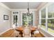 Dining room with natural light, wood floors, and a stylish chandelier at 5629 Clearsprings Dr, Wake Forest, NC 27587