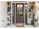 Close-up of front door with sidelights surrounded by stonework at 5629 Clearsprings Dr, Wake Forest, NC 27587