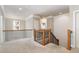 Upstairs hallway with natural light, white walls and trim, and wood banisters with black iron detail at 5629 Clearsprings Dr, Wake Forest, NC 27587