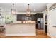 Gourmet kitchen island with stainless steel refrigerator and granite countertops at 5629 Clearsprings Dr, Wake Forest, NC 27587
