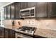 Gourmet kitchen showcases granite countertops, stainless steel appliances, and dark cabinets at 5629 Clearsprings Dr, Wake Forest, NC 27587