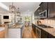 Gourmet kitchen with granite countertops and stainless steel appliances is open to living room at 5629 Clearsprings Dr, Wake Forest, NC 27587
