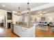 Kitchen island with granite countertops and stainless steel appliances overlooks living area at 5629 Clearsprings Dr, Wake Forest, NC 27587
