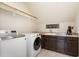 Practical laundry room with modern washer and dryer, countertops, and upper storage space at 5629 Clearsprings Dr, Wake Forest, NC 27587