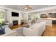 Open-concept living room features a fireplace, hardwood floors, and stylish furniture at 5629 Clearsprings Dr, Wake Forest, NC 27587