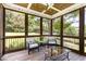 Comfortable screened porch with a wood paneled ceiling, outdoor furniture, and a view of the green backyard at 5629 Clearsprings Dr, Wake Forest, NC 27587