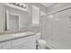 Bathroom with bright white vanity, granite countertop, and tiled shower at 5824 Cameo Glass Way, Raleigh, NC 27612