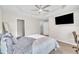 Bright primary bedroom featuring a ceiling fan, neutral walls, carpeted floors, and a walk-in closet at 5824 Cameo Glass Way, Raleigh, NC 27612