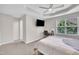 Bright bedroom with a ceiling fan, carpet flooring, neutral walls, a window and a desk at 5824 Cameo Glass Way, Raleigh, NC 27612