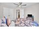 Bedroom with floral bedding, carpeted floor, ceiling fan, and double door closet at 5824 Cameo Glass Way, Raleigh, NC 27612