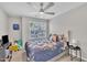 Bedroom with floral bedding, carpeted floor, ceiling fan, and natural light at 5824 Cameo Glass Way, Raleigh, NC 27612