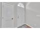 Bright entryway featuring a white door with transom window and hardwood floors at 5824 Cameo Glass Way, Raleigh, NC 27612