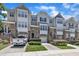 Charming townhome with stone accents, attached garages, and well-manicured landscaping, offering a desirable curb appeal at 5824 Cameo Glass Way, Raleigh, NC 27612