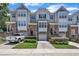 Charming townhome with stone accents, attached garages, and well-manicured landscaping, offering a desirable curb appeal at 5824 Cameo Glass Way, Raleigh, NC 27612