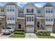 Charming townhome with stone accents, attached garages, and well-manicured landscaping, offering a desirable curb appeal at 5824 Cameo Glass Way, Raleigh, NC 27612