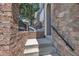 Exterior entrance with brick, stone, and iron railing, creating a sophisticated and secure entryway at 5824 Cameo Glass Way, Raleigh, NC 27612
